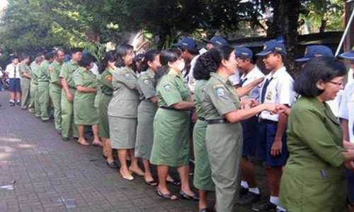 Guru SMP 3 Denpasar menyalami para siswa usai upacara bendera (ist)